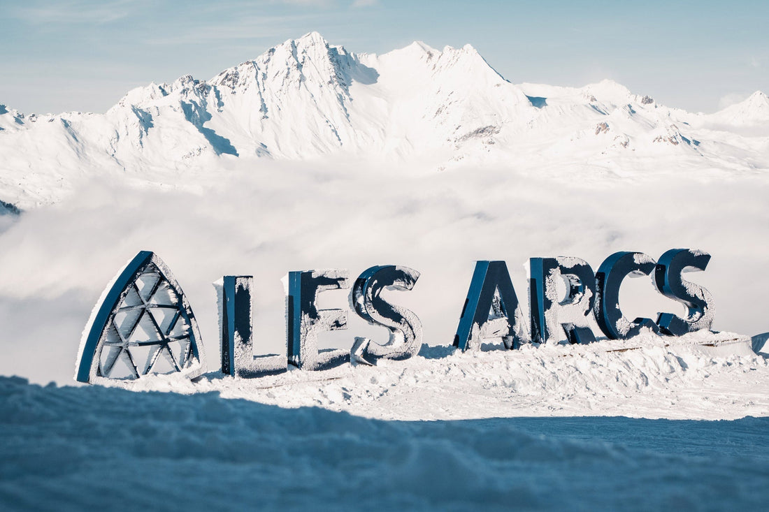 A sunny day at Les Arcs, there is a sign spelling the resort’s name in giant letters.