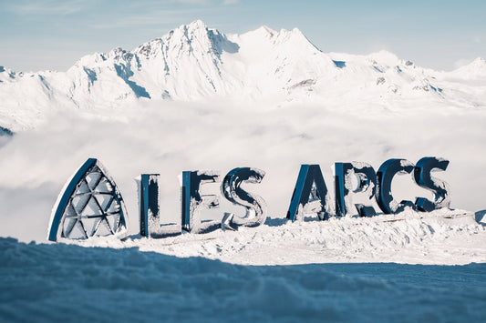 A sunny day at Les Arcs, there is a sign spelling the resort’s name in giant letters.