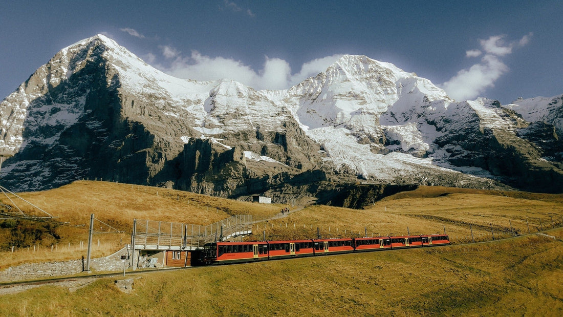 The Jungfraubahn passes through yellow fields in front of the Jungfraujoch