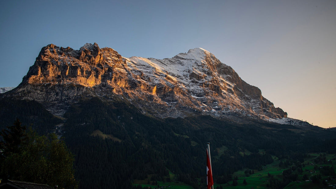Sunrise over the Swiss Alps in autumn. The mountain top has a sprinkling of fresh snow. 